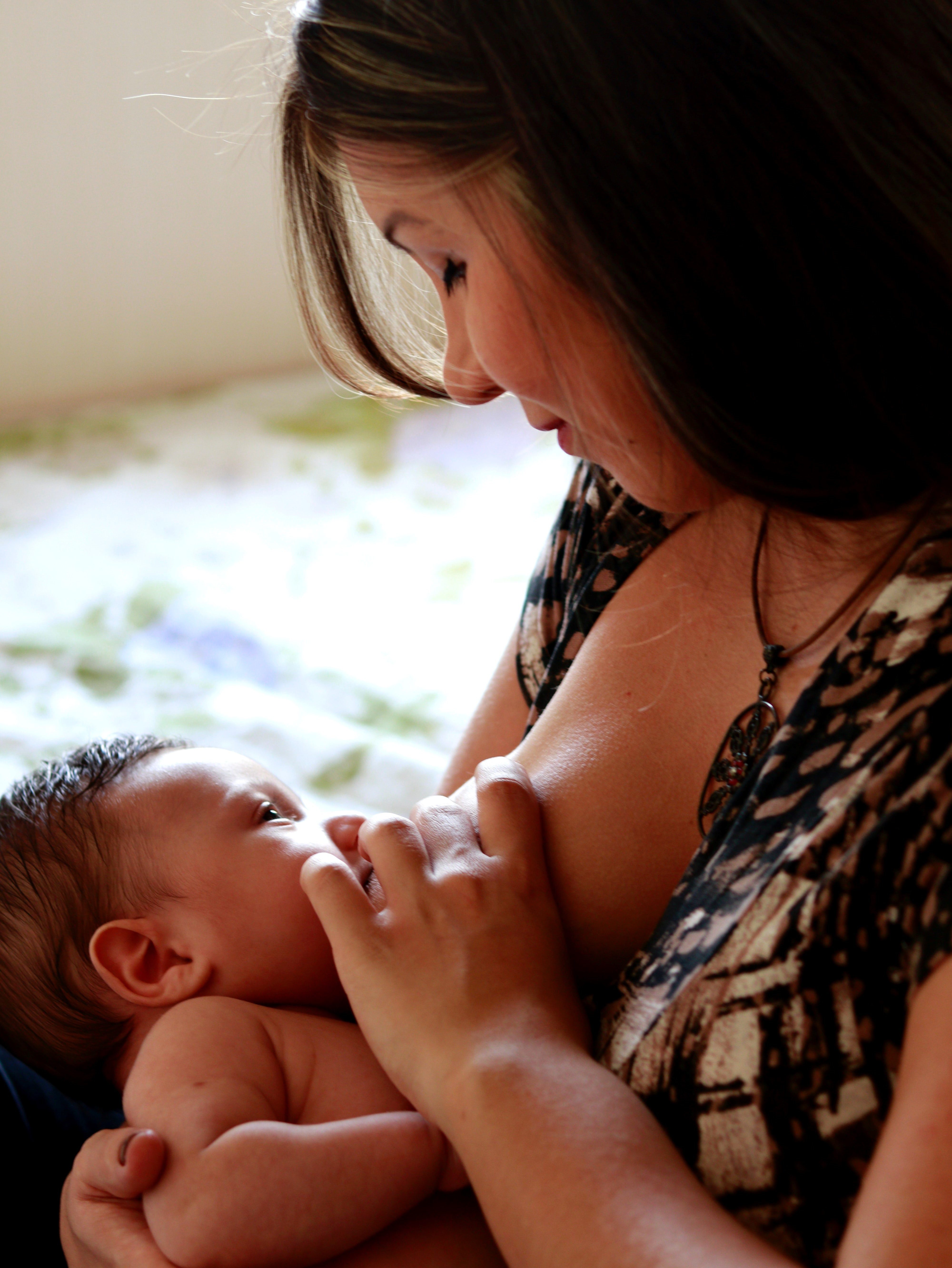 A woman breast feeding her baby