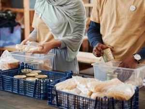 Five Ways to Wellbeing 7 Two volunteers packing food in boxes