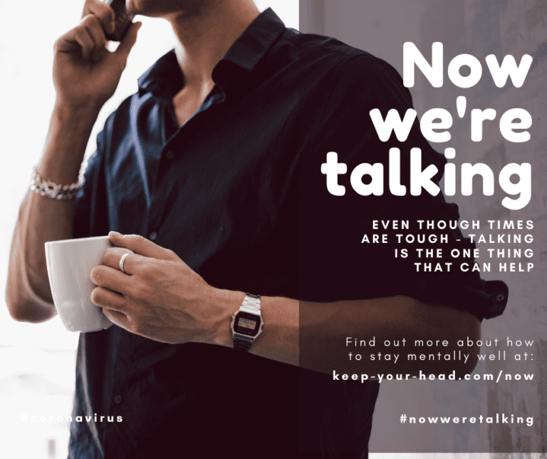 A man on the phone holding a mug with text saying Now we're talking. Even though times are tough - talking is the one thing that can help. Find out more about how to stay mentally well at: keep-your-head.com/now #nowweretalking #coronavirus
