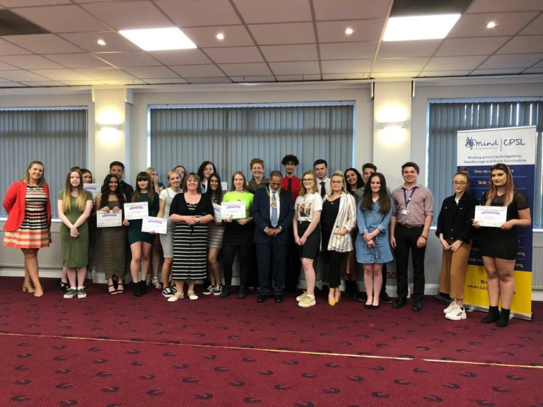 A group of people holding certificates