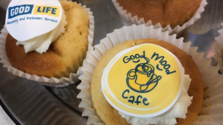 Cupcakes with the Good Mood Cafe and Good Life logos on them
