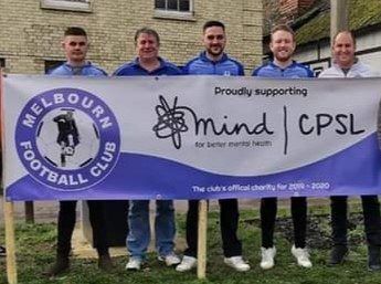 Group of men standing behind a Melbourn Football Club proudly supporting CPSL Mind banner