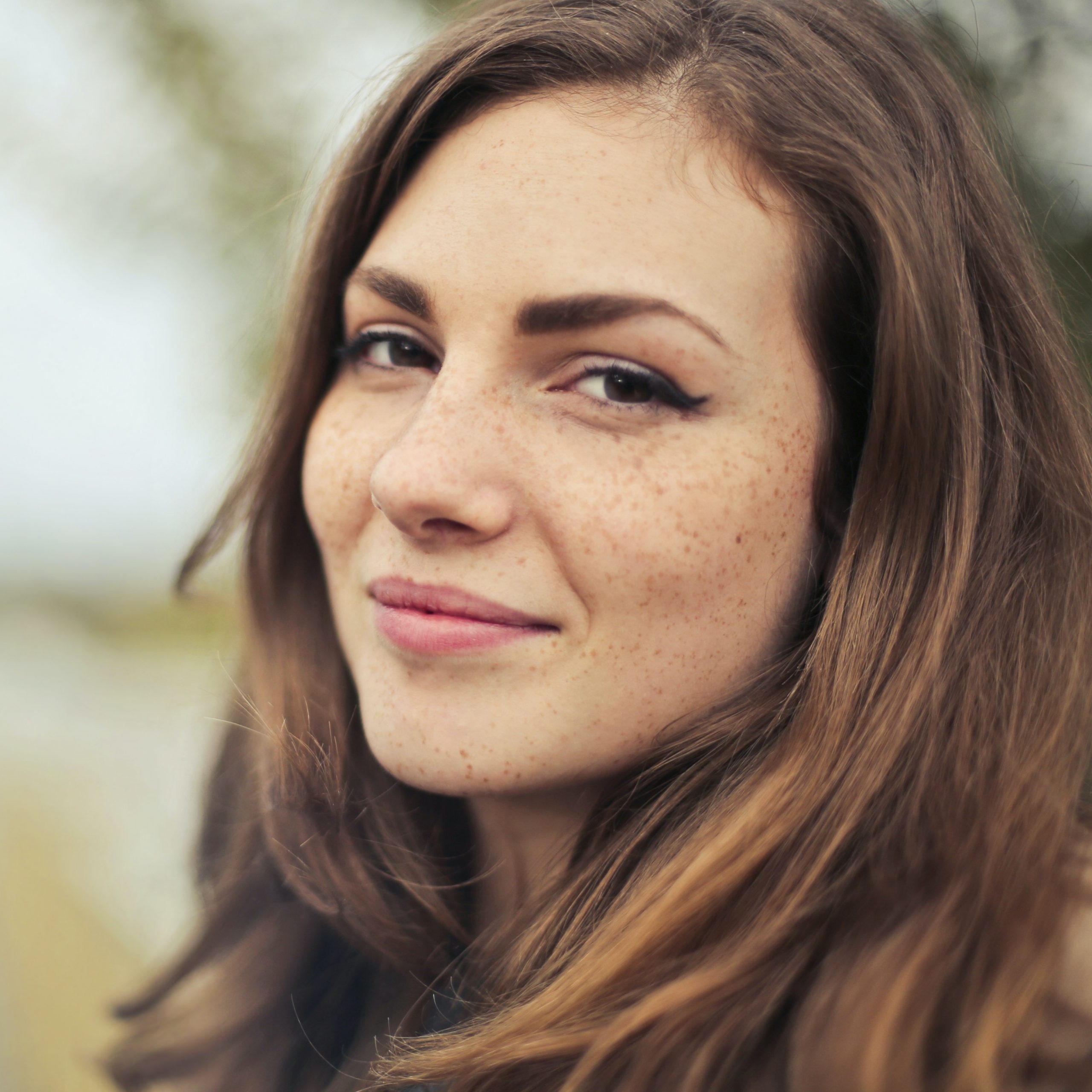 Dark haired girl smiling at the camera