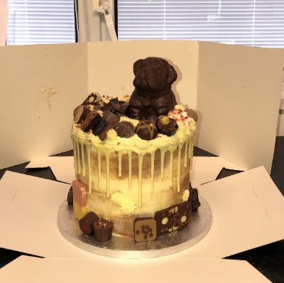 A cake with white chocolate a dark chocolate decoration
