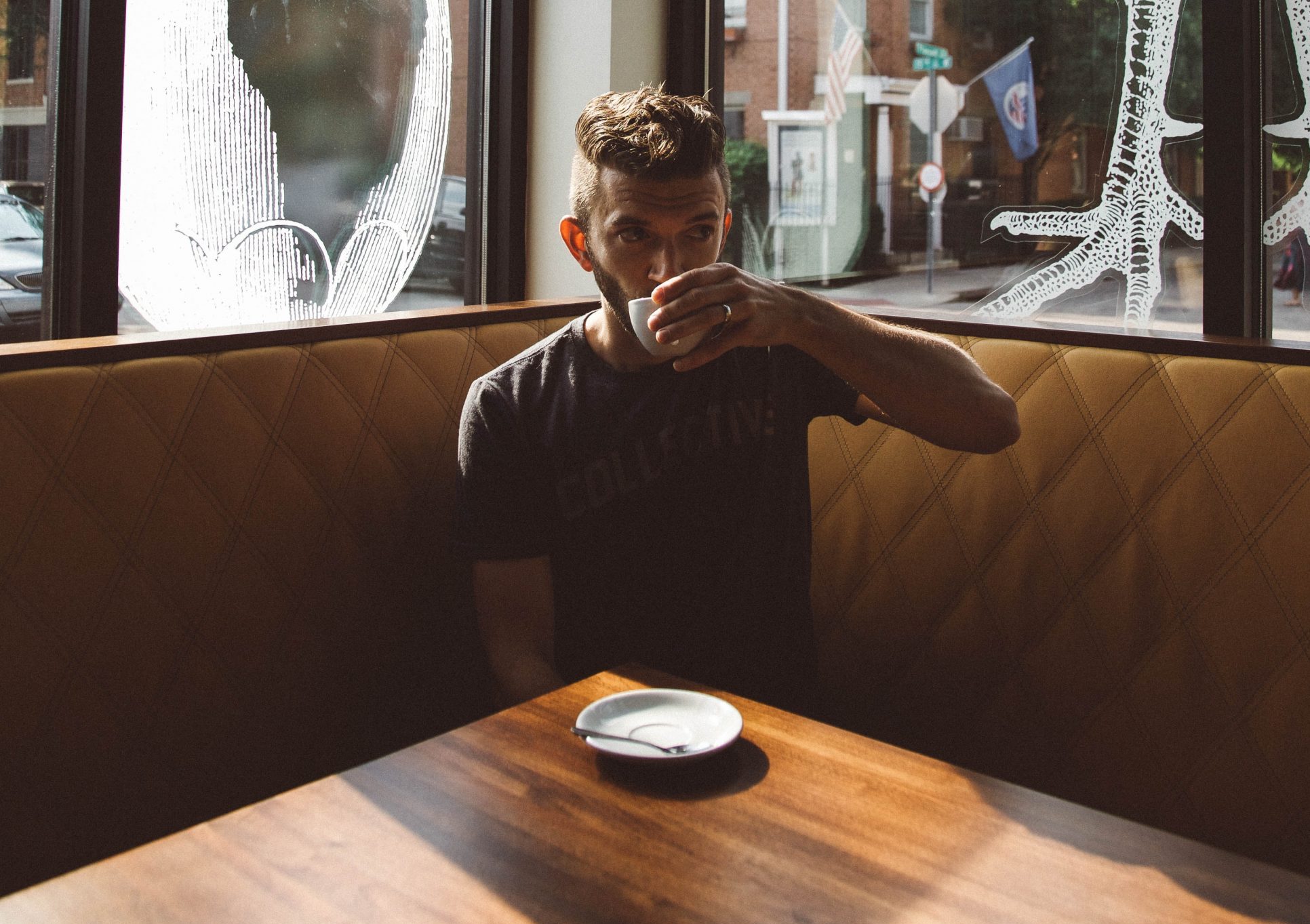 A man drinking coffee in a cafe