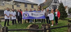 A group of people holding a CPSL Mind banner