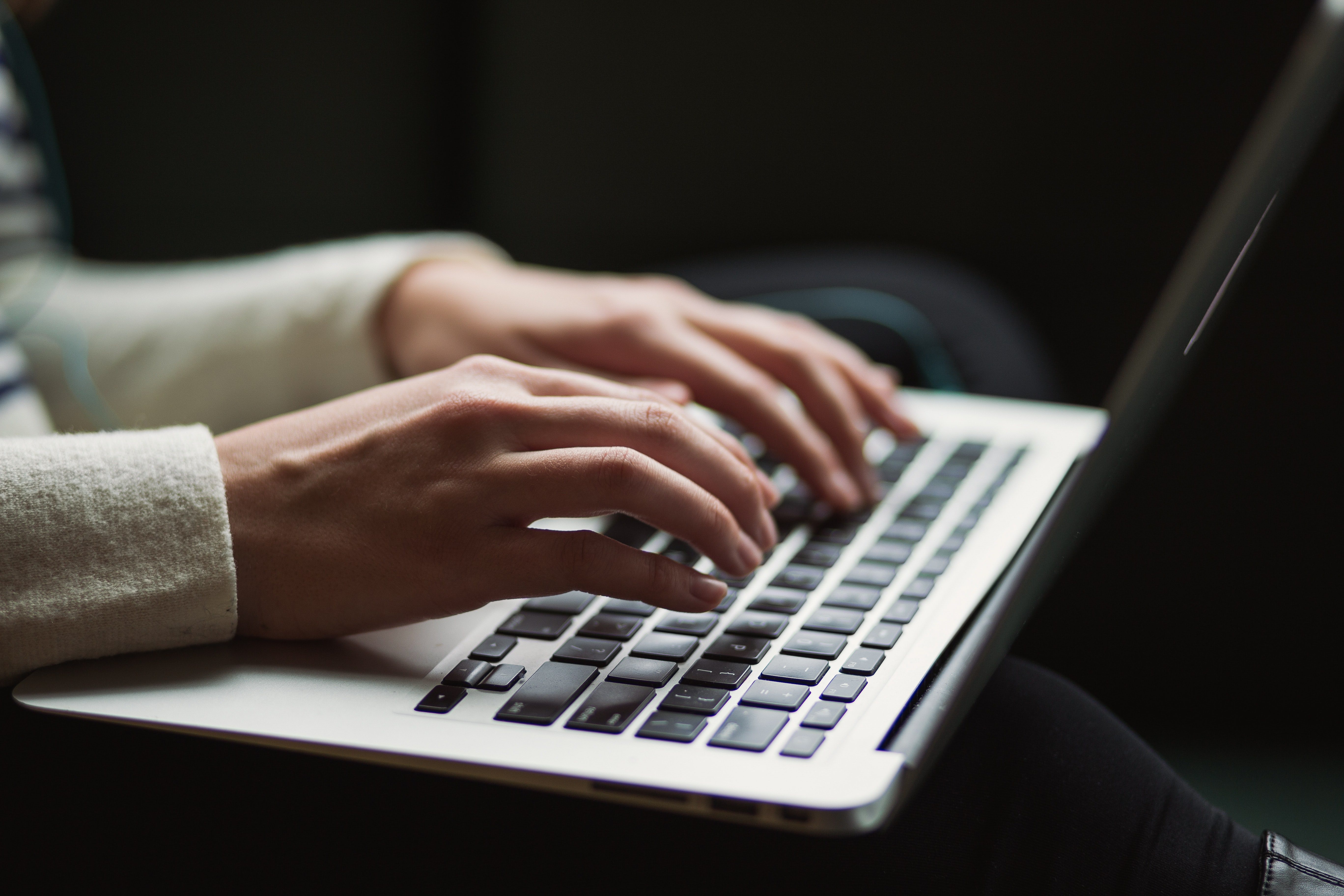 A woman typing on laptop
