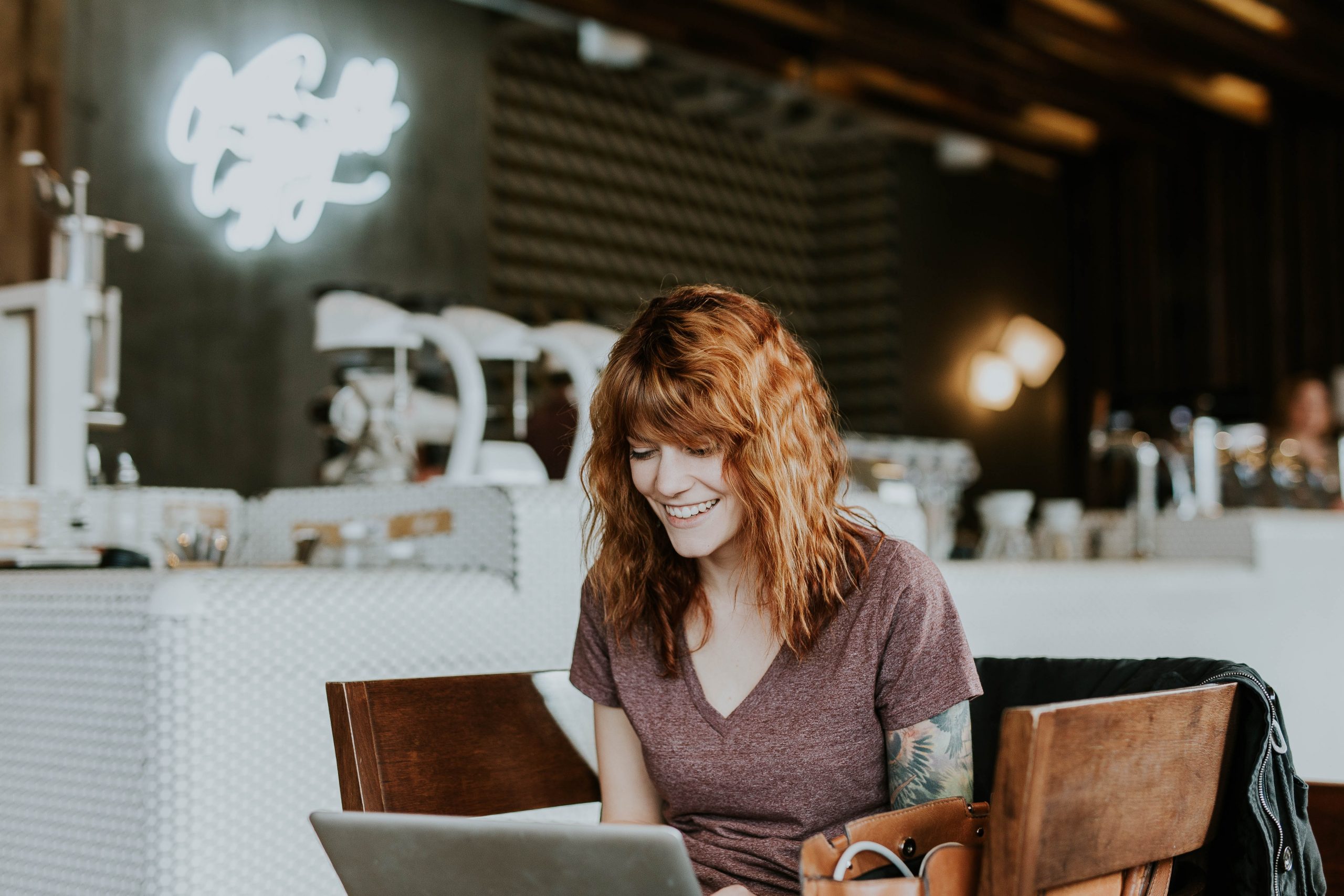 Woman sitting in a cafe with a laptop