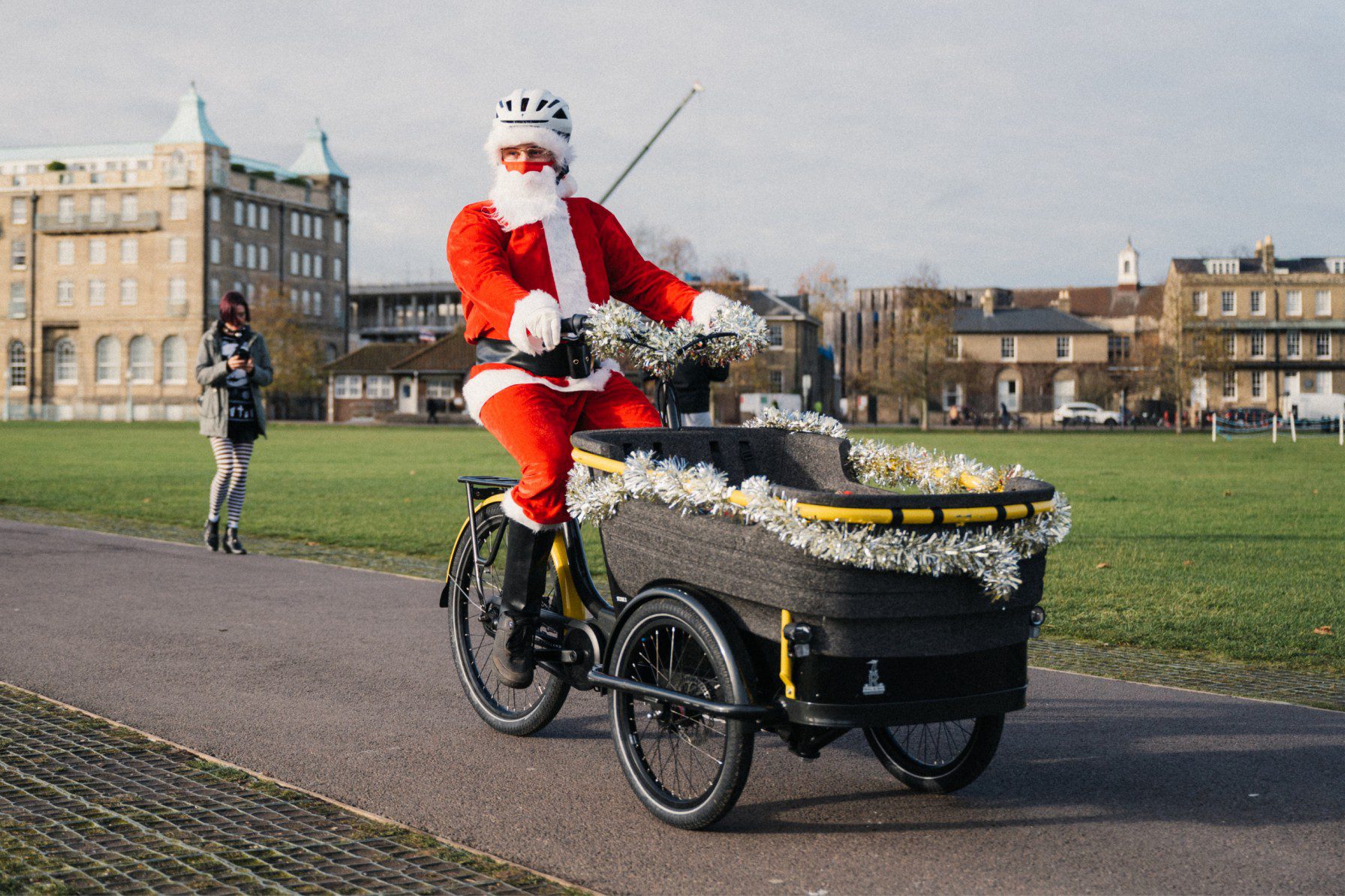 Man dressed as Santa Claus riding a bicycle