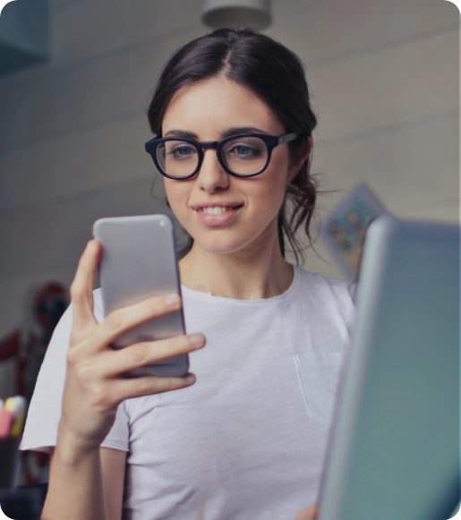 woman in glasses looking at phone