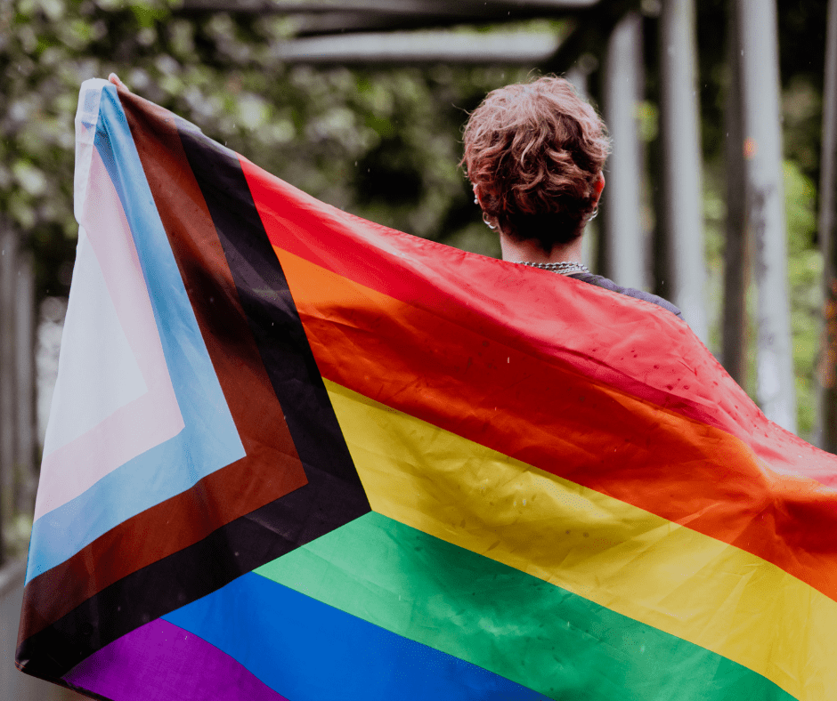 A person holding the pride flag
