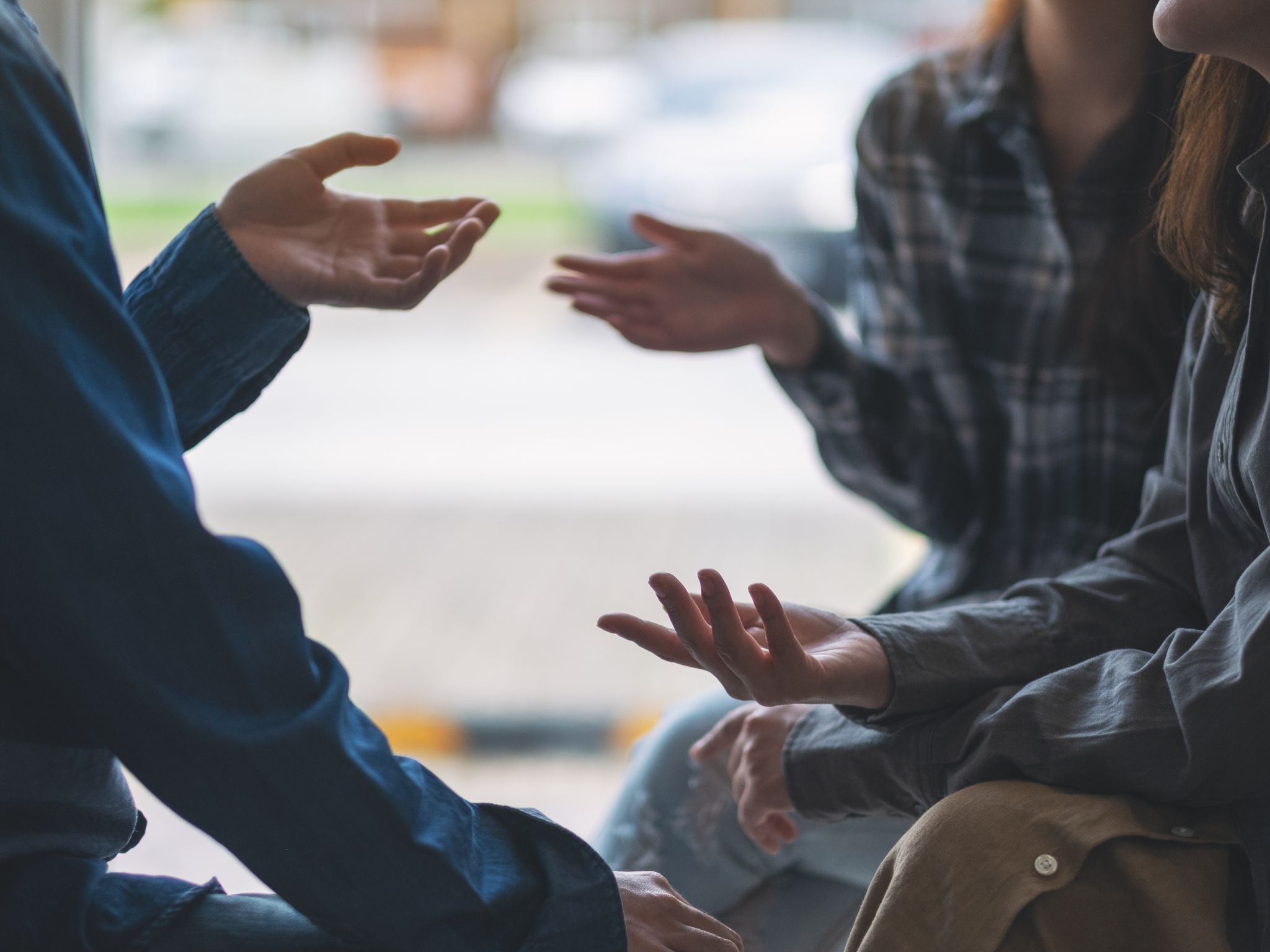 peer support in Cambridgeshire and Peterborough - three people talking with hands out