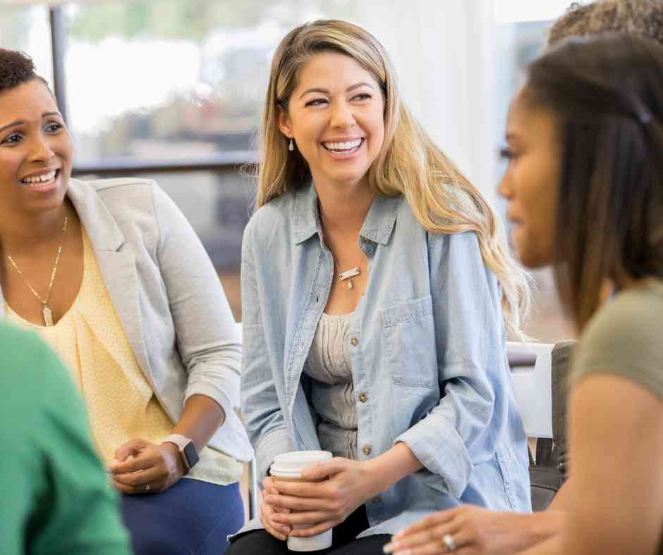 A woman smiling in a Peer Support Group - Volunteer Peer Mentor