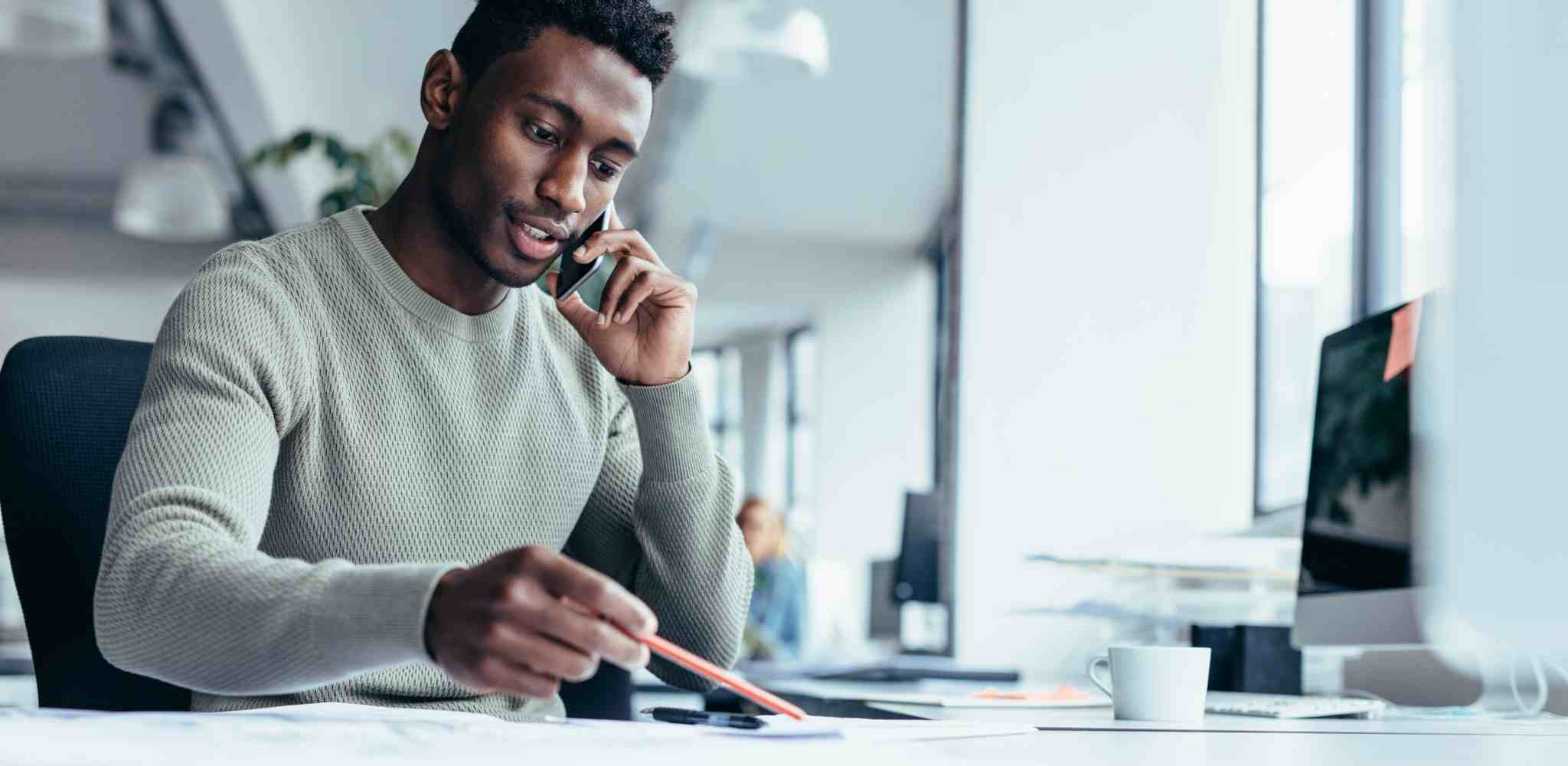 A man on a call at the office - Information and Enquiries Co-ordinator