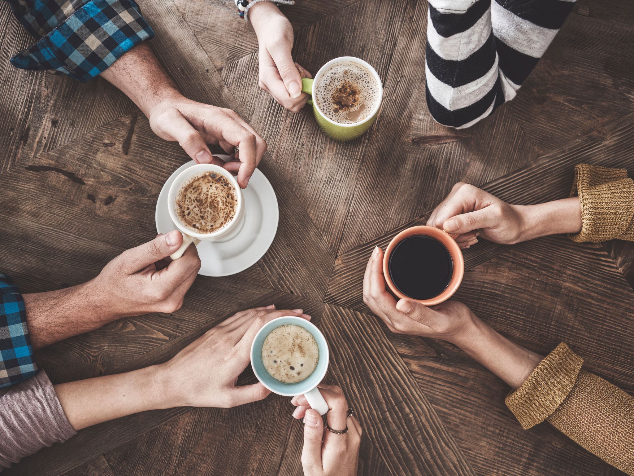 People holding coffee mugs