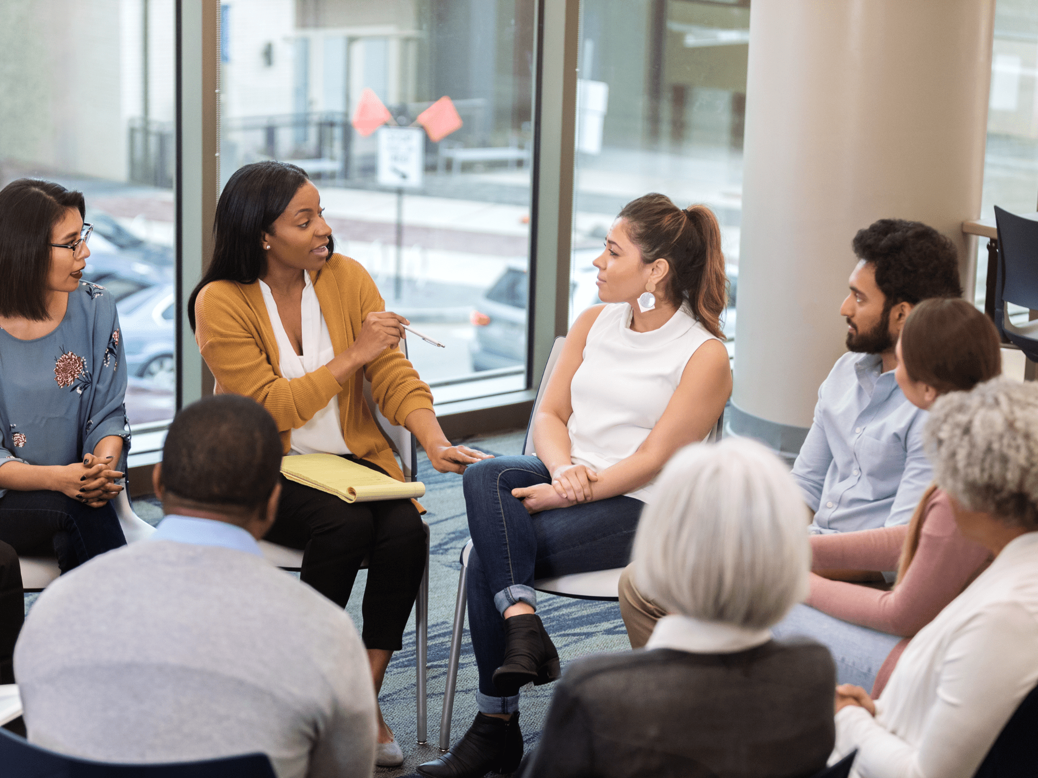 A group of people sitting together for a training course - Self-Harm Course