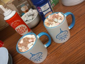 white and blue mug of hot chocolate