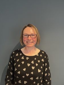 Image of a woman wearing black top with hearts