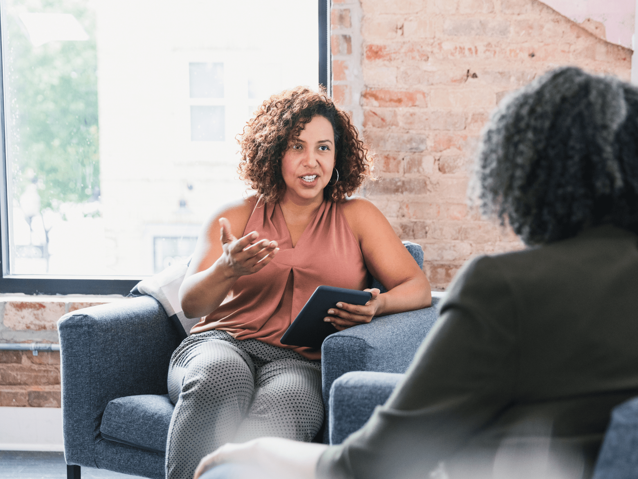 lady in pink top sitting on chair