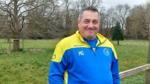 Image of man in yellow and blue jacket