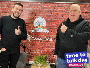 two men with thumbs up smiling to camera