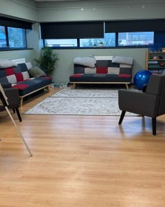 room with chairs and sofas