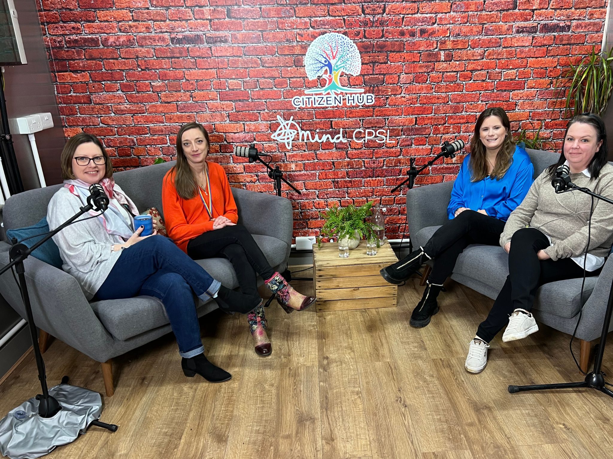 women sitting on sofa in podcast studio