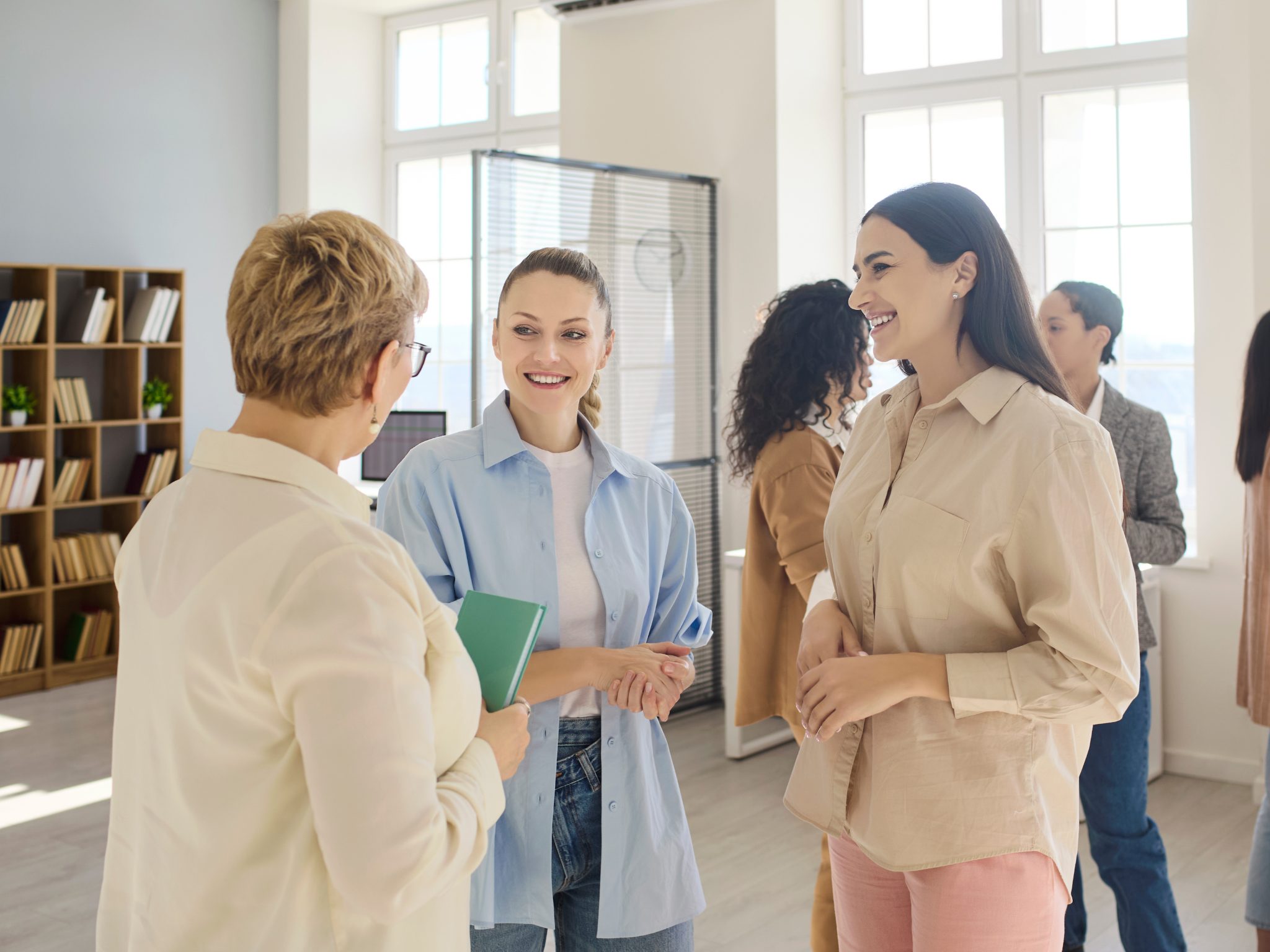 group of people standing in office