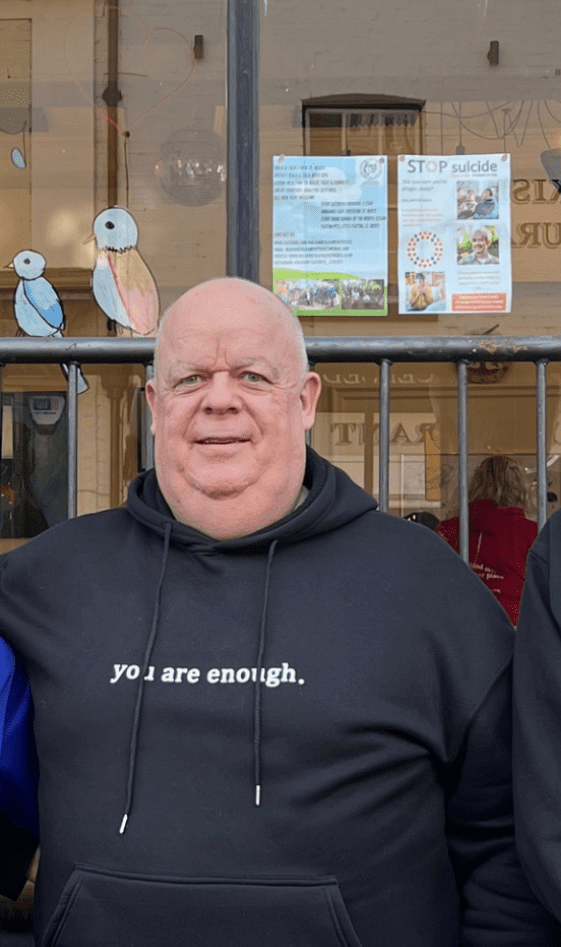 man wearing black hoody smiling