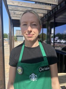lady with blonde hair wearing green apron