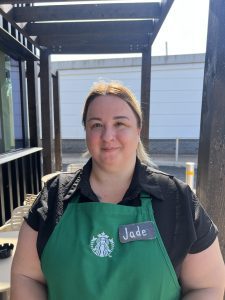 women wearing green apron standing outside