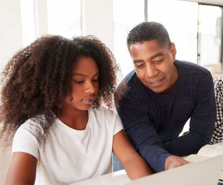 How Parents Can Support Their Child’s Move to University or a New Career Journey 5 Four people sit together at a table with laptops and books, working and talking in a bright, modern room.