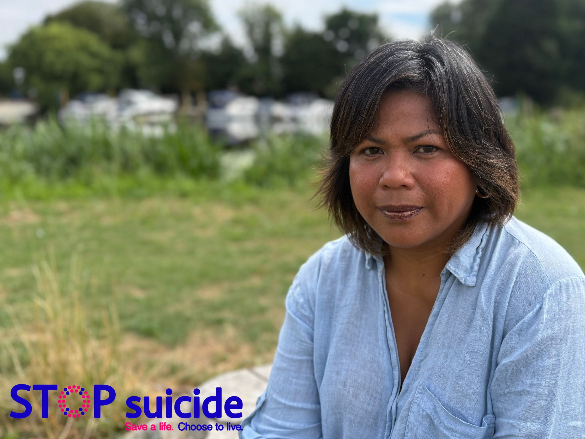lady with brown hair wearing a blue shirt